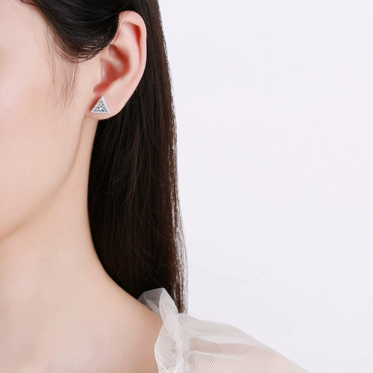 Trillion Moissanite Stud Earrings with CZ in Rhodium-Plated S925 sterling silver worn on ear by model showing scale, placement, and stud earrings styling