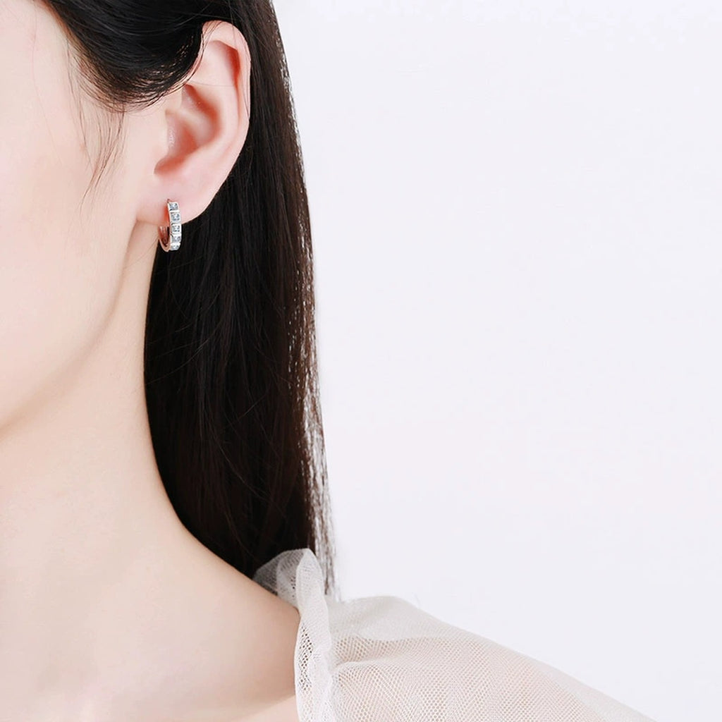 Princess Cut Moissanite Hoop Earrings in Rhodium-Plated S925 sterling silver worn on ear by model showing scale, placement, and hoop earrings styling