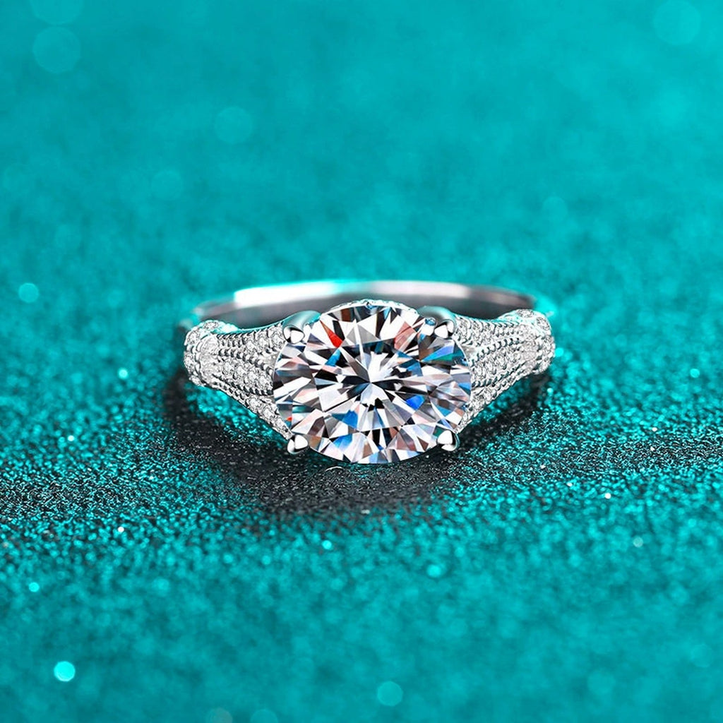 Oval Cut Moissanite Side Stone Engagement Ring with CZ product view showing moissanite setting and metal finish