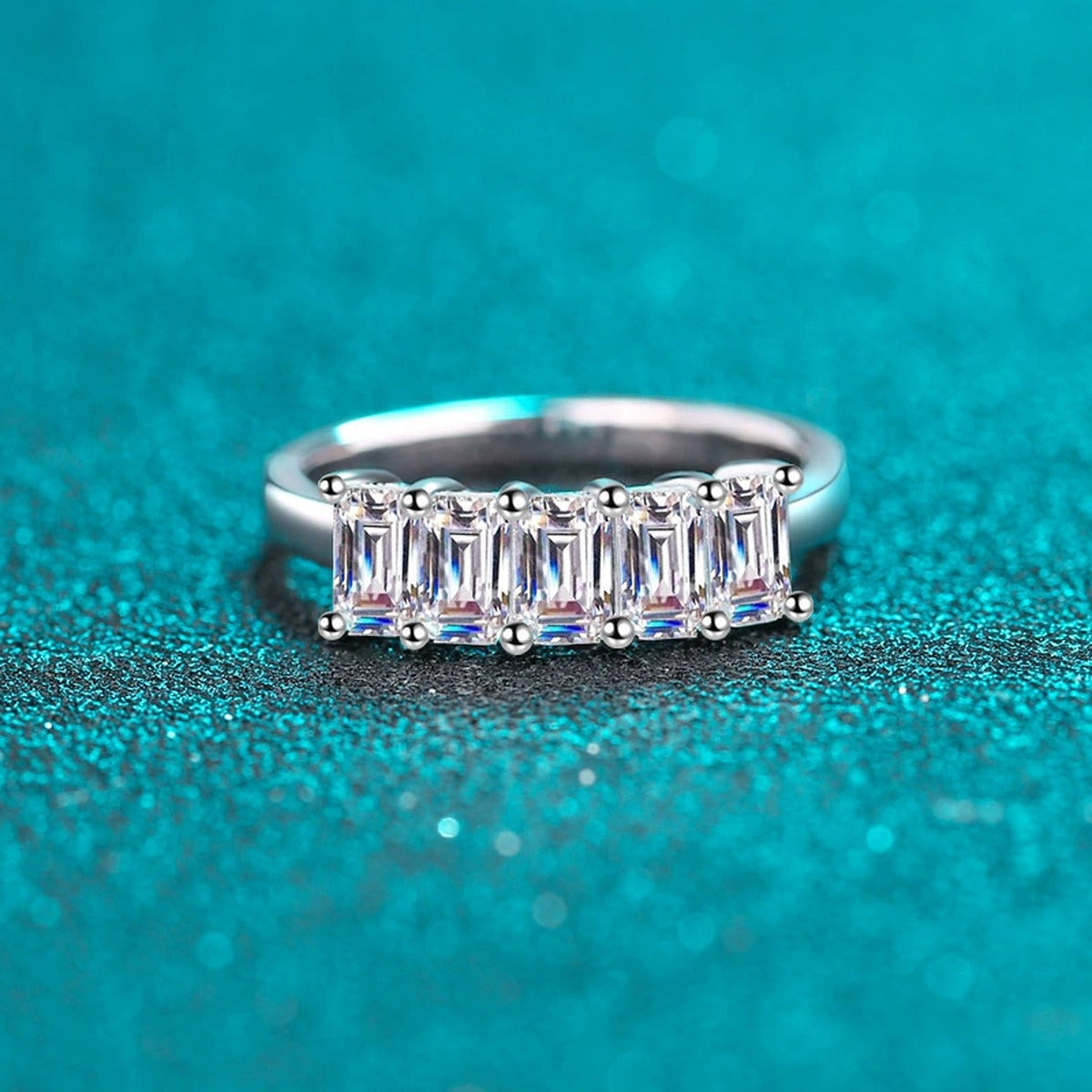 Emerald Cut Moissanite Five Stone Band Ring in Rhodium-Plated S925 Sterling Silver blue display product photo showing the moissanite setting, stone cut, and band profile