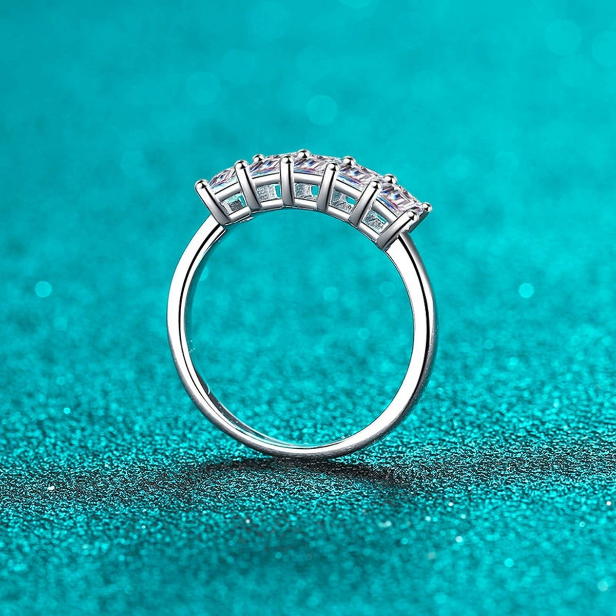 Emerald Cut Moissanite Five Stone Band Ring in Rhodium-Plated S925 Sterling Silver blue display product photo showing the moissanite setting, stone cut, and band profile