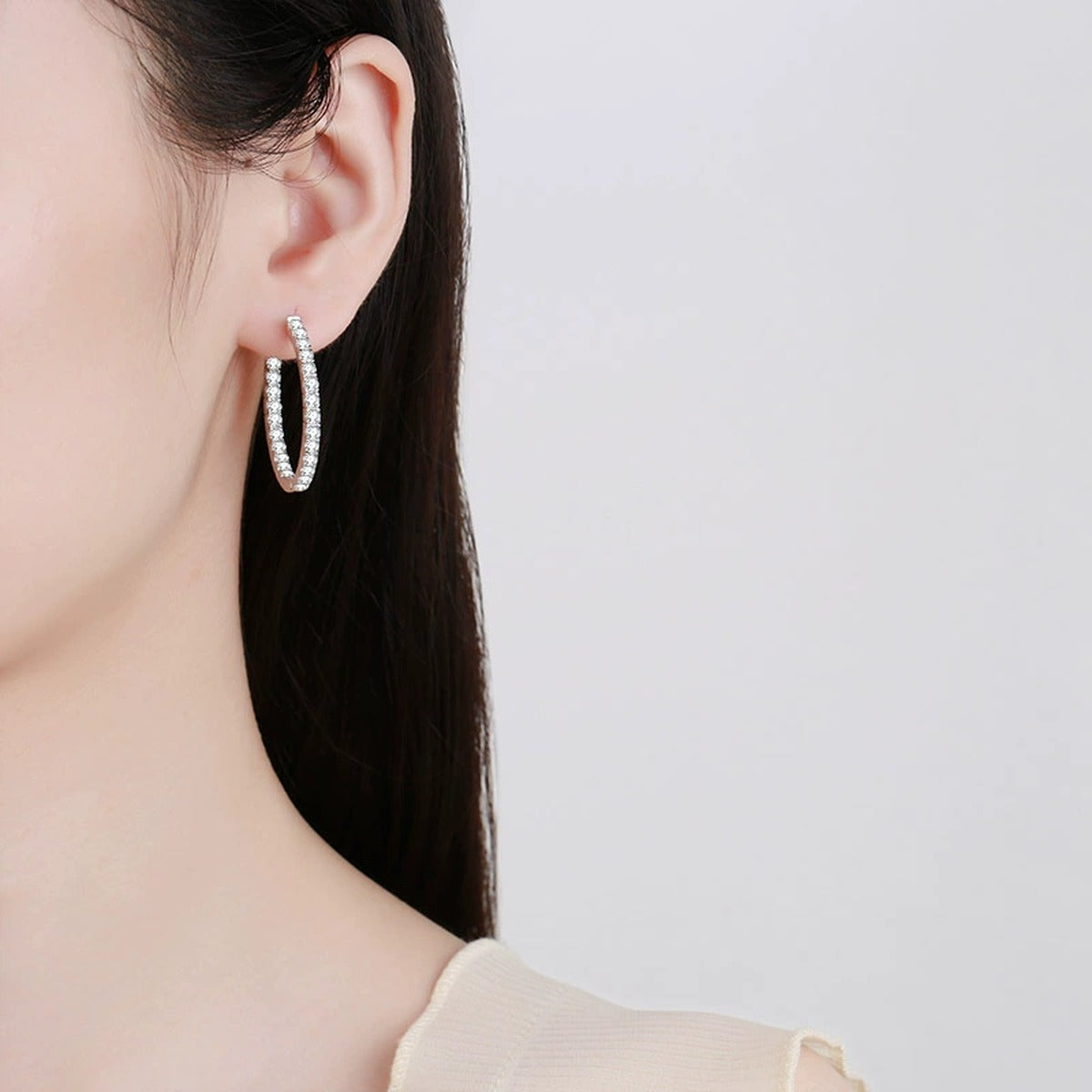 Pave Moissanite Hoop Earrings in Rhodium-Plated S925 sterling silver worn on ear by model showing scale, placement, and hoop earrings styling