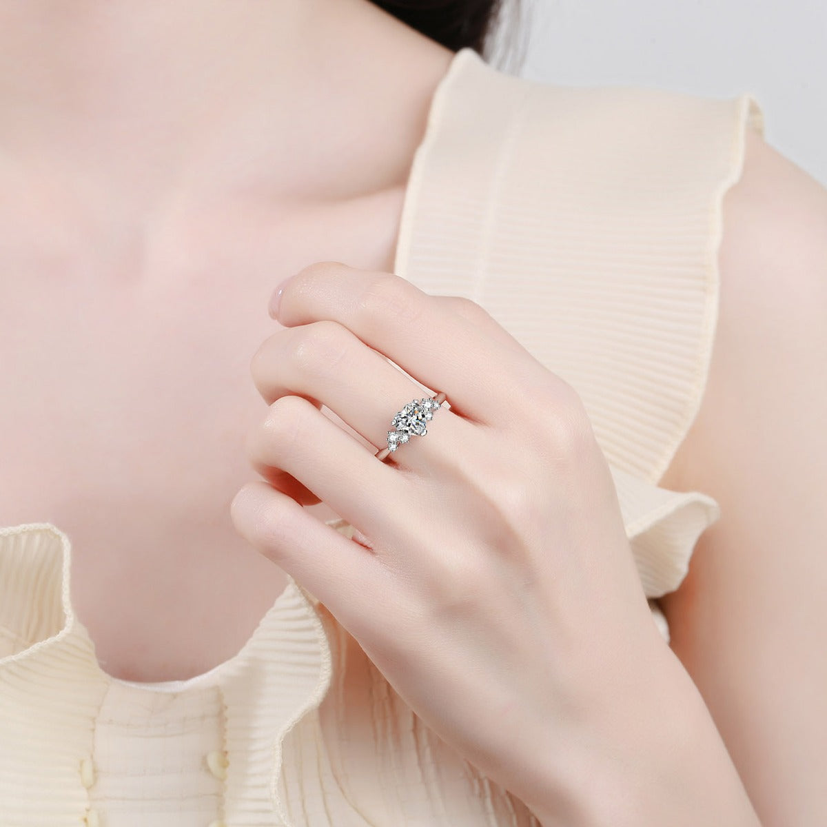 Heart Cut Moissanite Side Stone Engagement Ring with CZ in Rhodium-Plated S925 Sterling Silver worn on hand, showing scale, finger coverage, and rhodium-plated finish