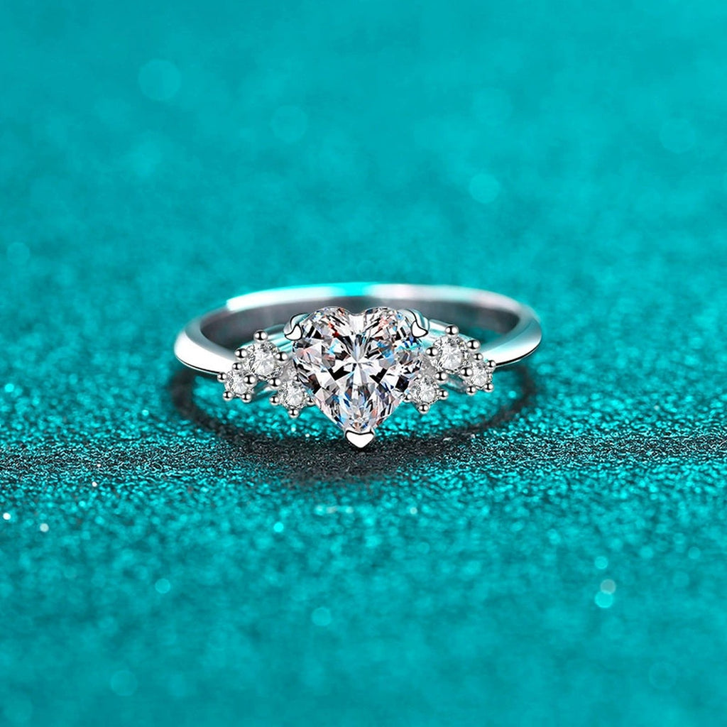 Heart Cut Moissanite Side Stone Engagement Ring with CZ in Rhodium-Plated S925 Sterling Silver blue display product photo showing the moissanite setting, stone cut, and band profile