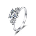 Heart Cut Moissanite Side Stone Engagement Ring with CZ in Rhodium-Plated S925 Sterling Silver clean white background product photo showing the ring silhouette and moissanite setting