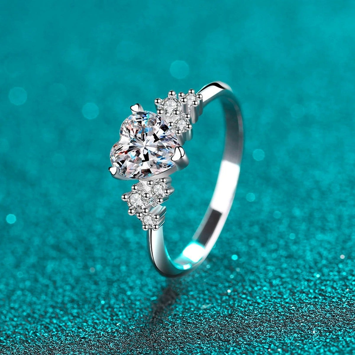 Heart Cut Moissanite Side Stone Engagement Ring with CZ in Rhodium-Plated S925 Sterling Silver blue display product photo showing the moissanite setting, stone cut, and band profile