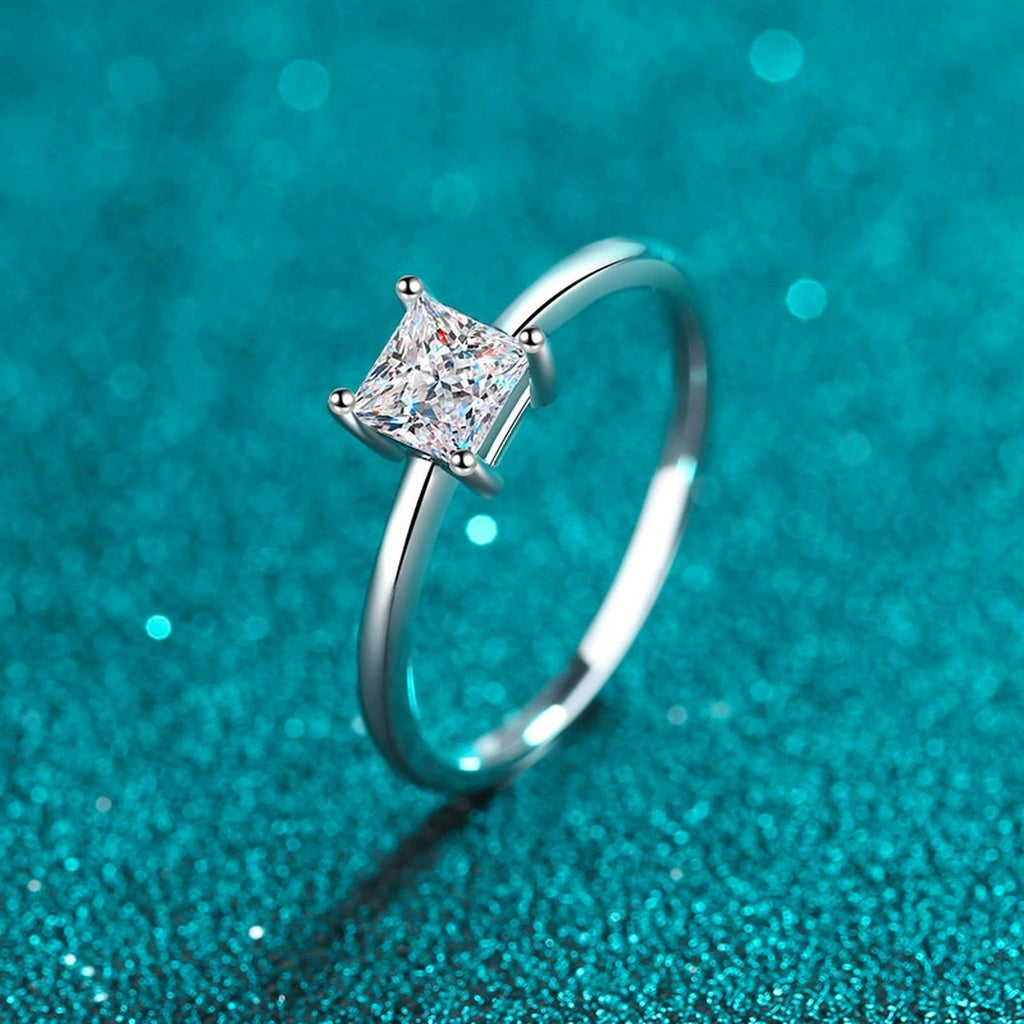 Princess Cut Moissanite Solitaire Ring in Rhodium-Plated S925 Sterling Silver blue display product photo showing the moissanite setting, stone cut, and band profile