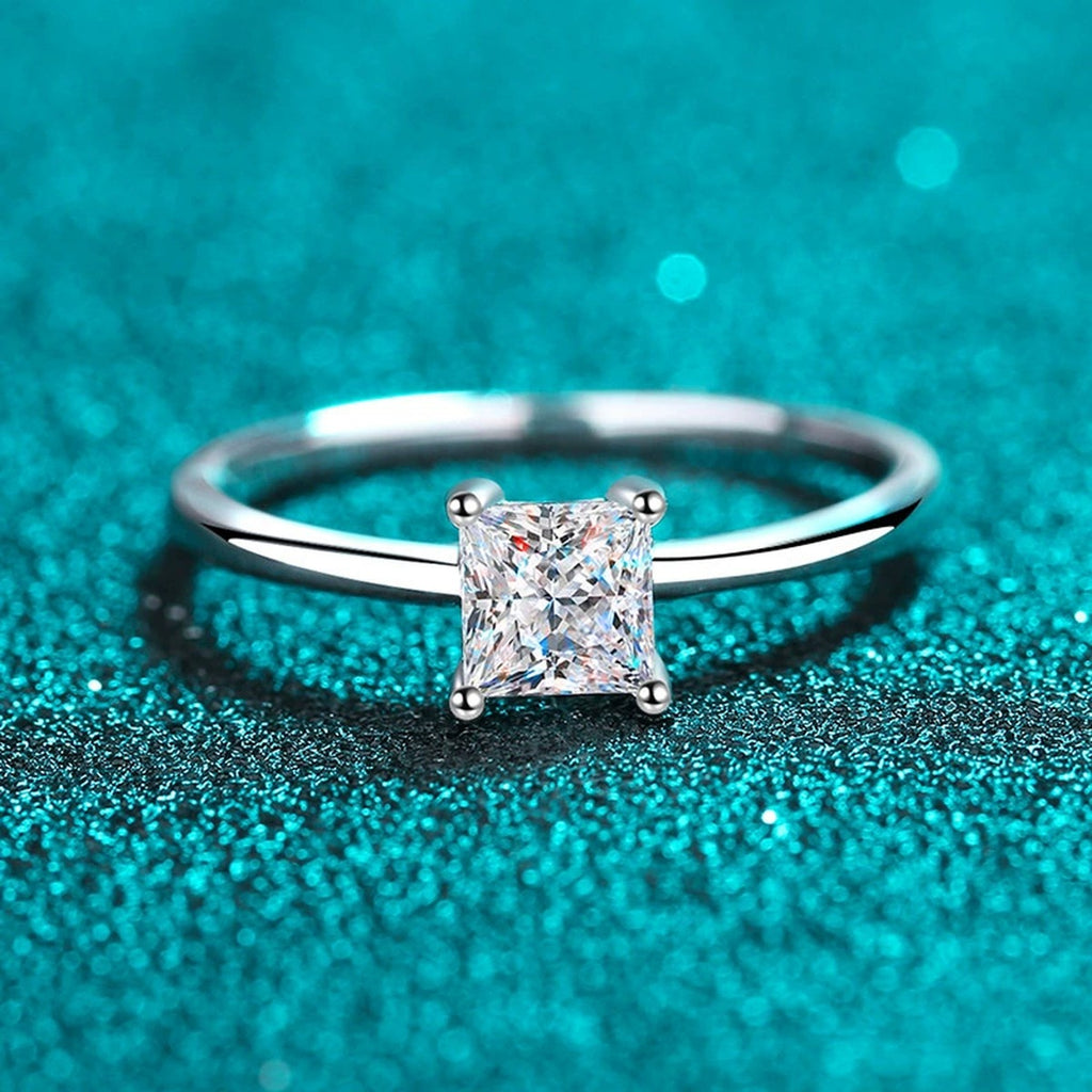 Princess Cut Moissanite Solitaire Ring in Rhodium-Plated S925 Sterling Silver blue display product photo showing the moissanite setting, stone cut, and band profile