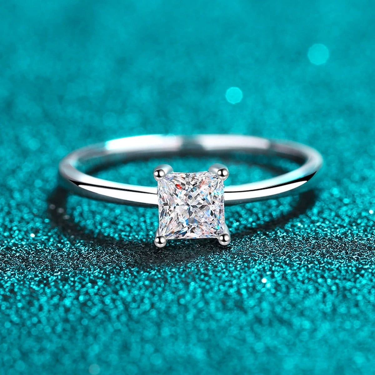 Princess Cut Moissanite Solitaire Ring in Rhodium-Plated S925 Sterling Silver blue display product photo showing the moissanite setting, stone cut, and band profile