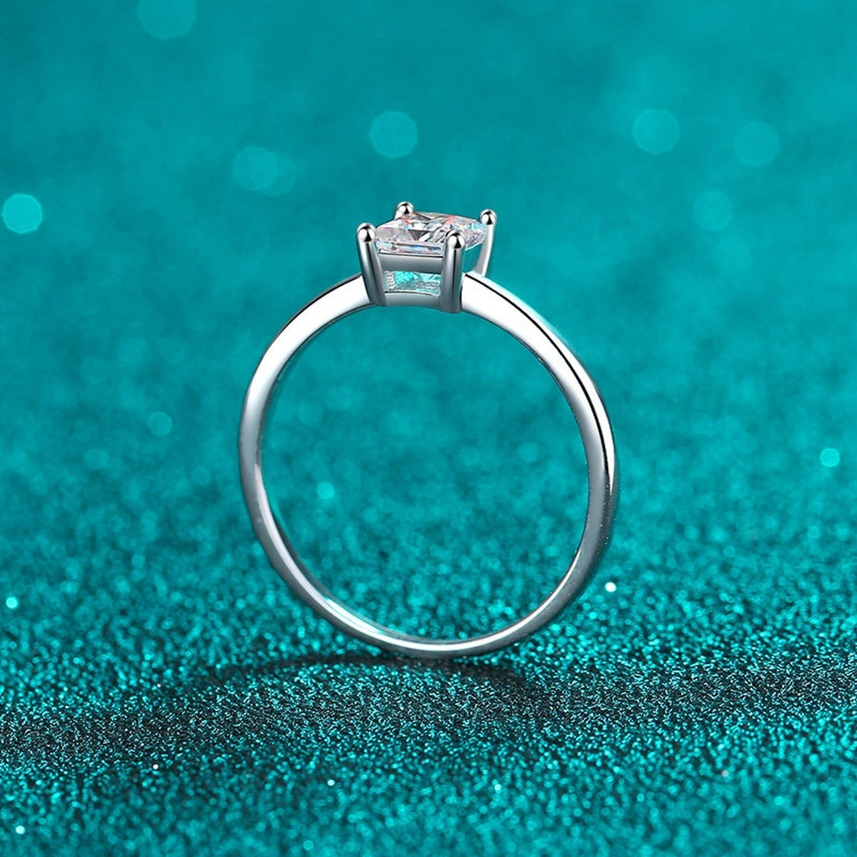 Princess Cut Moissanite Solitaire Ring in Rhodium-Plated S925 Sterling Silver blue display product photo showing the moissanite setting, stone cut, and band profile