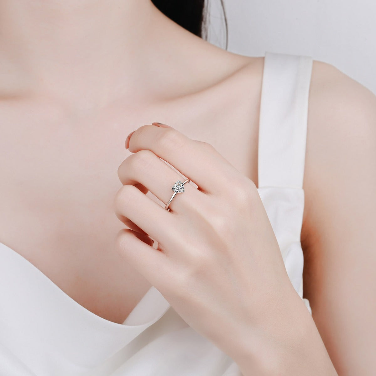 Heart Cut Moissanite Promise Ring in Rhodium-Plated S925 Sterling Silver worn on hand, showing scale, finger coverage, and rhodium-plated finish