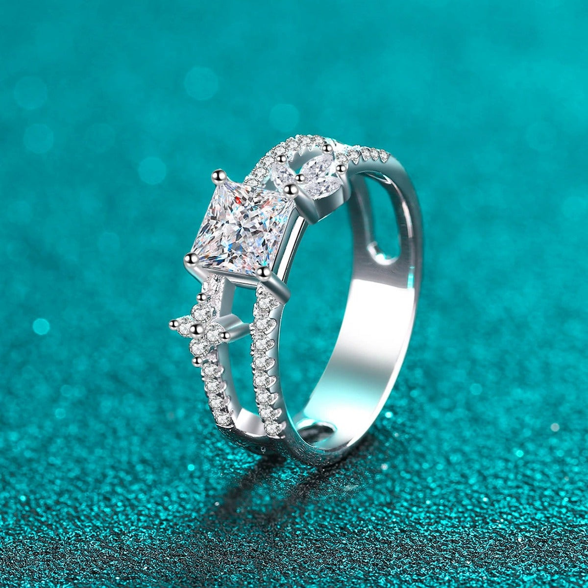 Princess Cut Moissanite Side Stone Engagement Ring with CZ in Rhodium-Plated S925 Sterling Silver blue display product photo showing the moissanite setting, stone cut, and band profile