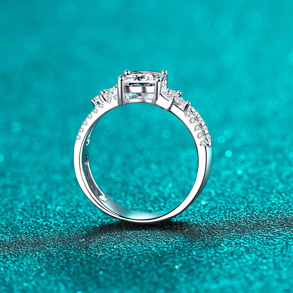 Princess Cut Moissanite Side Stone Engagement Ring with CZ in Rhodium-Plated S925 Sterling Silver blue display product photo showing the moissanite setting, stone cut, and band profile