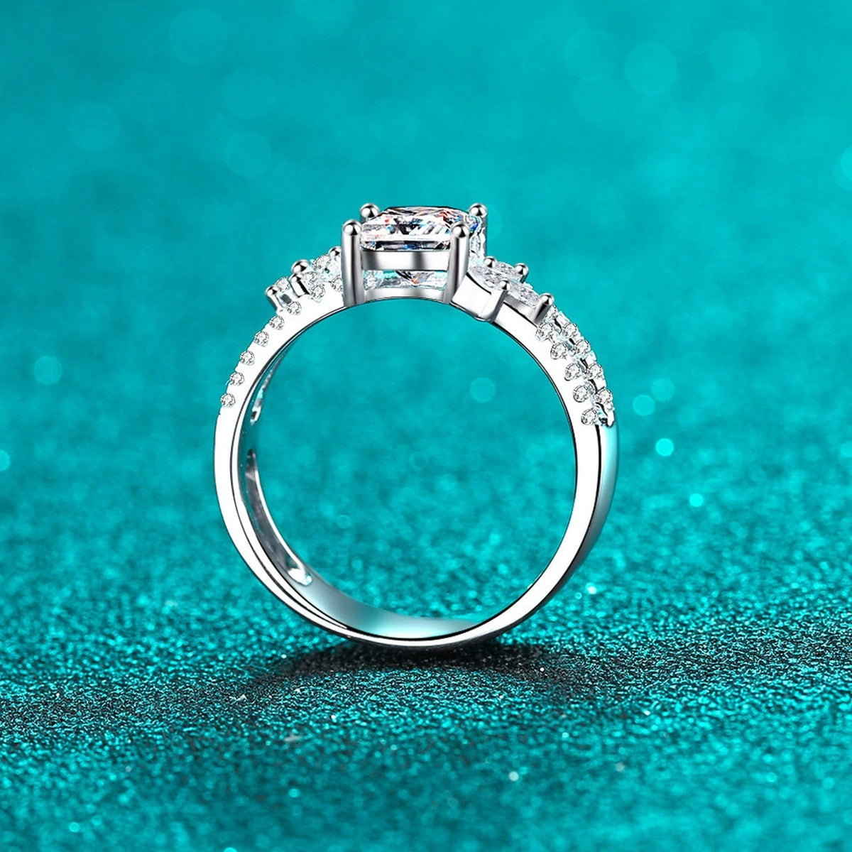 Princess Cut Moissanite Side Stone Engagement Ring with CZ in Rhodium-Plated S925 Sterling Silver blue display product photo showing the moissanite setting, stone cut, and band profile
