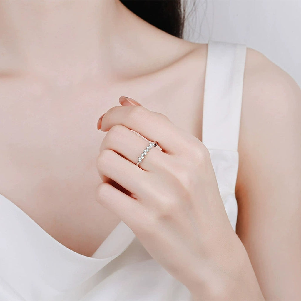 Dainty Round Moissanite Band Ring worn on hand to show scale and ring profile