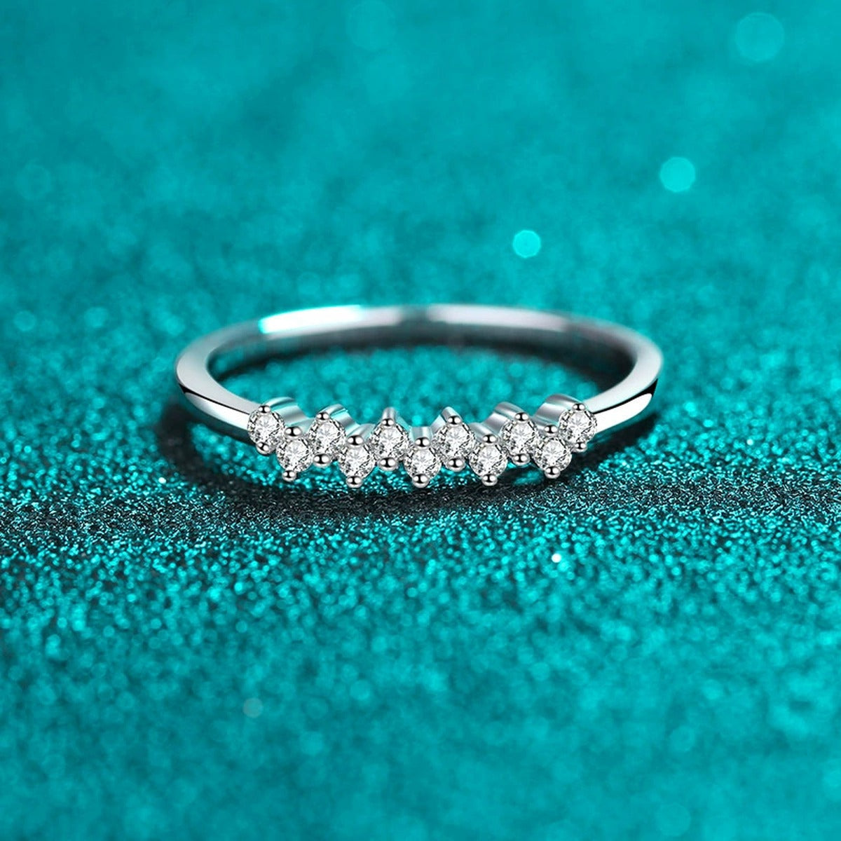 Dainty Round Moissanite Band Ring product view showing moissanite setting and rhodium finish