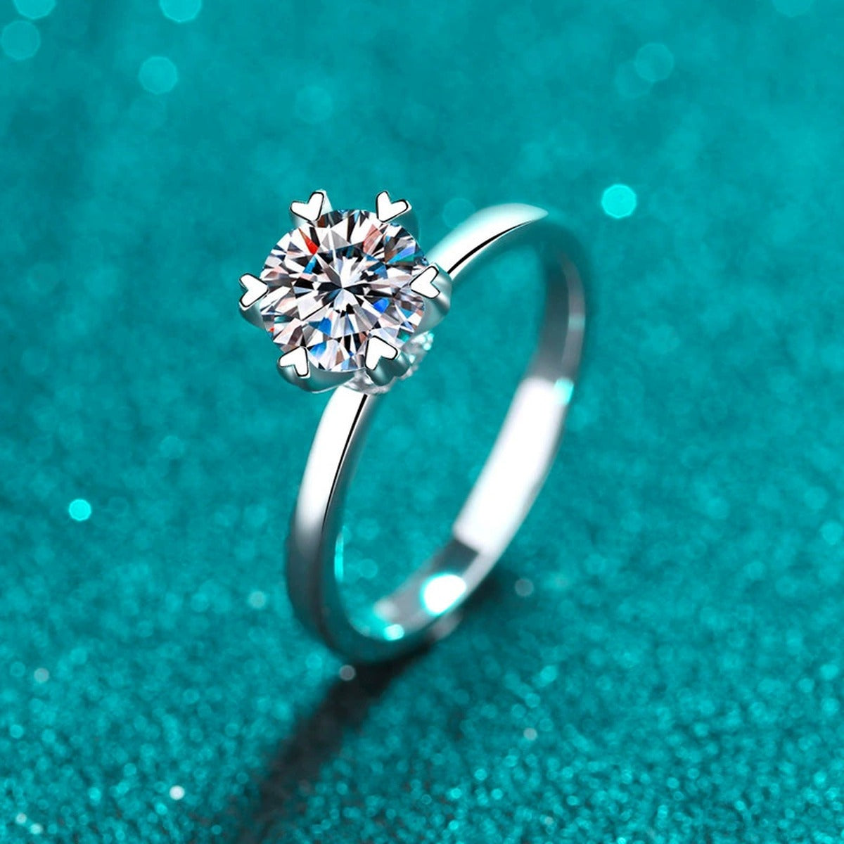 Round Moissanite Side Stone Engagement Ring with CZ in Rhodium-Plated S925 Sterling Silver blue display product photo showing the moissanite setting, stone cut, and band profile