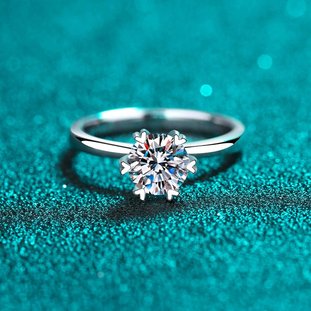Round Moissanite Side Stone Engagement Ring with CZ in Rhodium-Plated S925 Sterling Silver blue display product photo showing the moissanite setting, stone cut, and band profile