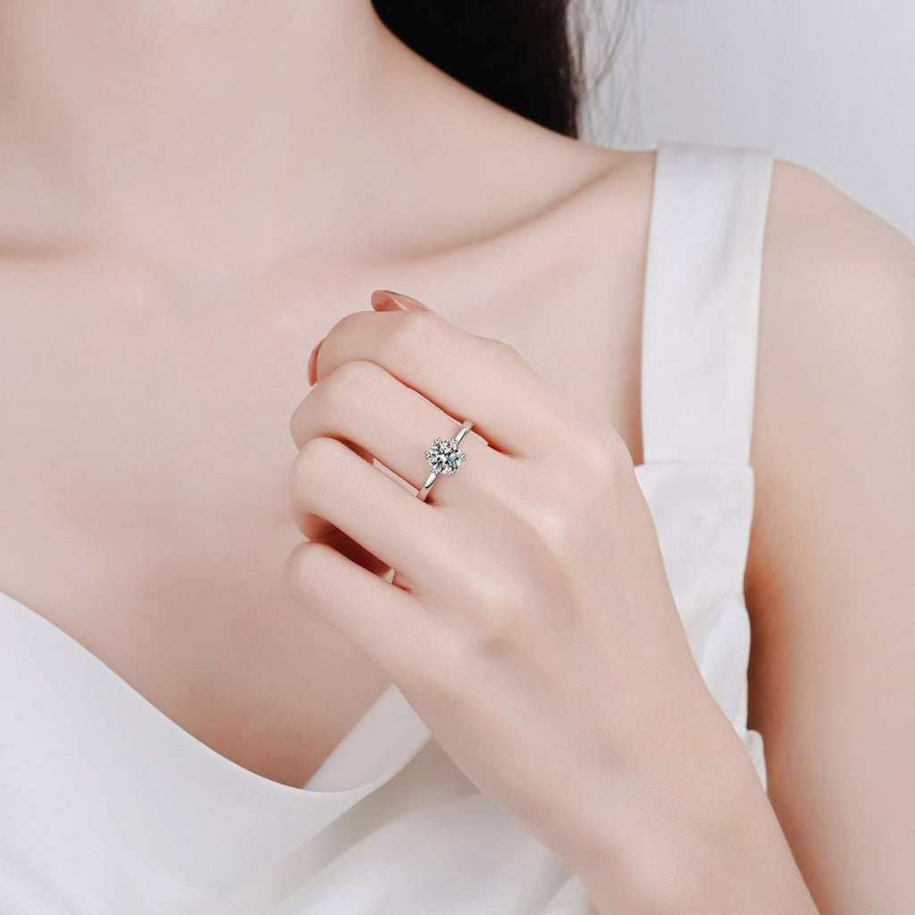 Round Moissanite Side Stone Engagement Ring with CZ in Rhodium-Plated S925 Sterling Silver worn on hand, showing scale, finger coverage, and rhodium-plated finish