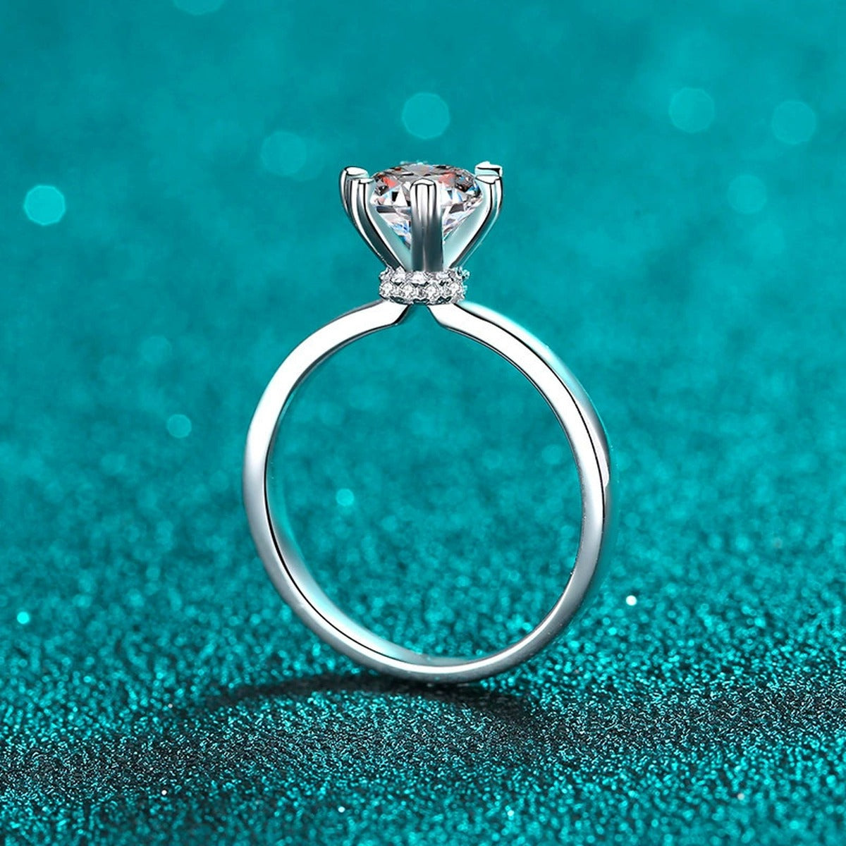 Round Moissanite Side Stone Engagement Ring with CZ in Rhodium-Plated S925 Sterling Silver blue display product photo showing the moissanite setting, stone cut, and band profile