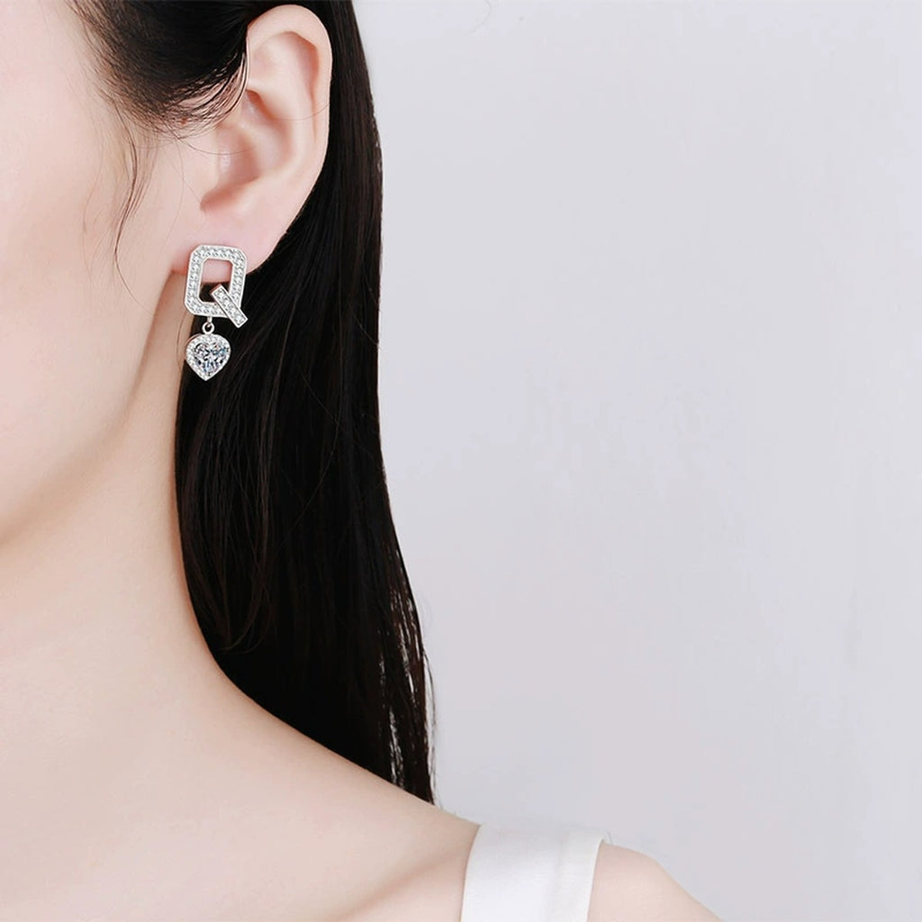 Heart Moissanite Stud Dangle Earrings with CZ in Rhodium-Plated S925 sterling silver worn on ear by model showing scale, placement, and stud dangle earrings styling