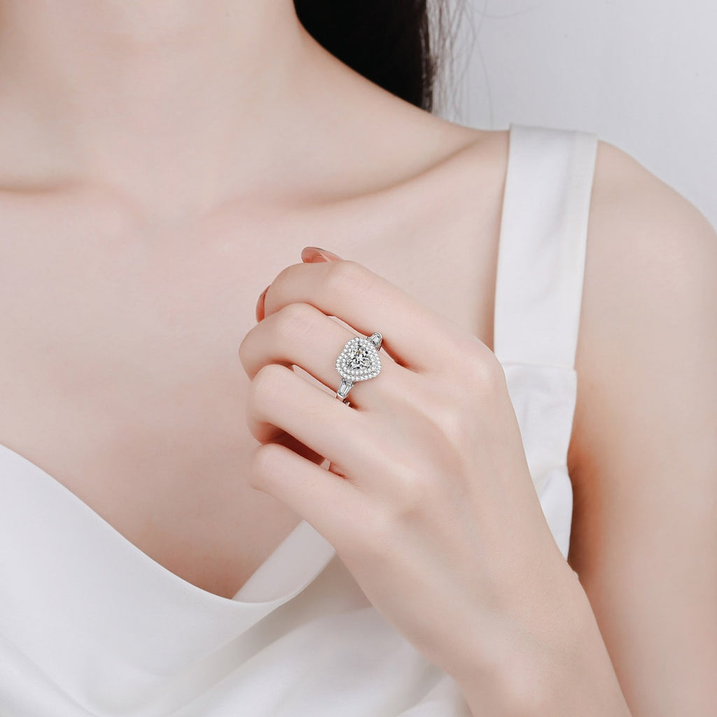 Heart Cut Moissanite Side Stone Engagement Ring with CZ in Rhodium-Plated S925 Sterling Silver worn on hand, showing scale, finger coverage, and rhodium-plated finish