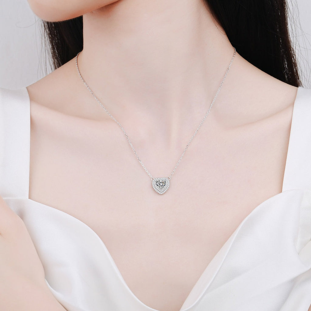 Heart Cut Moissanite Pendant Necklace with CZ in Rhodium-Plated S925 sterling silver worn on neckline by model showing scale and adjustable chain styling