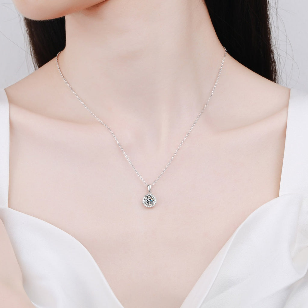 Round Halo Moissanite Pendant Necklace with CZ in Rhodium-Plated S925 sterling silver worn on neckline by model showing scale and adjustable chain styling