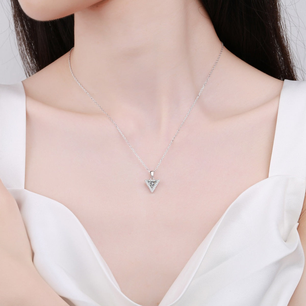 Trillion Cut Moissanite Pendant Necklace with CZ in Rhodium-Plated S925 sterling silver worn on neckline by model showing scale and adjustable chain styling