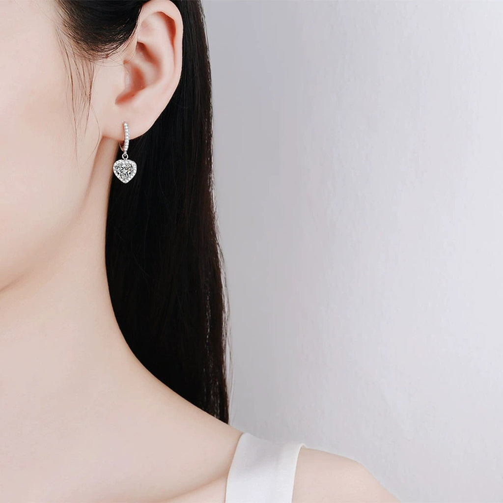 Heart Moissanite Hoop Dangle Earrings with CZ in Rhodium-Plated S925 sterling silver worn on ear by model showing scale, placement, and hoop dangle earrings styling