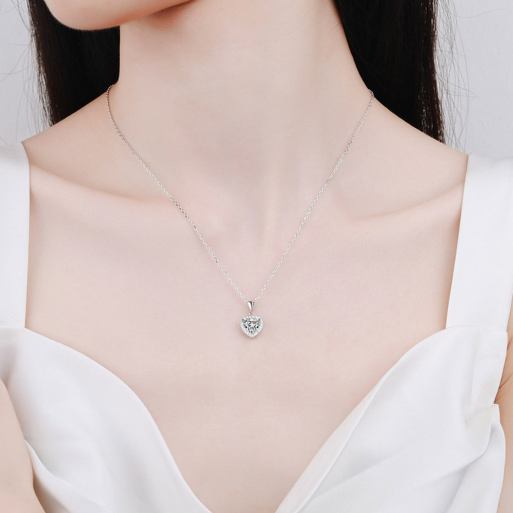 Heart Halo Moissanite Pendant Necklace with CZ in Rhodium-Plated S925 sterling silver worn on neckline by model showing scale and adjustable chain styling