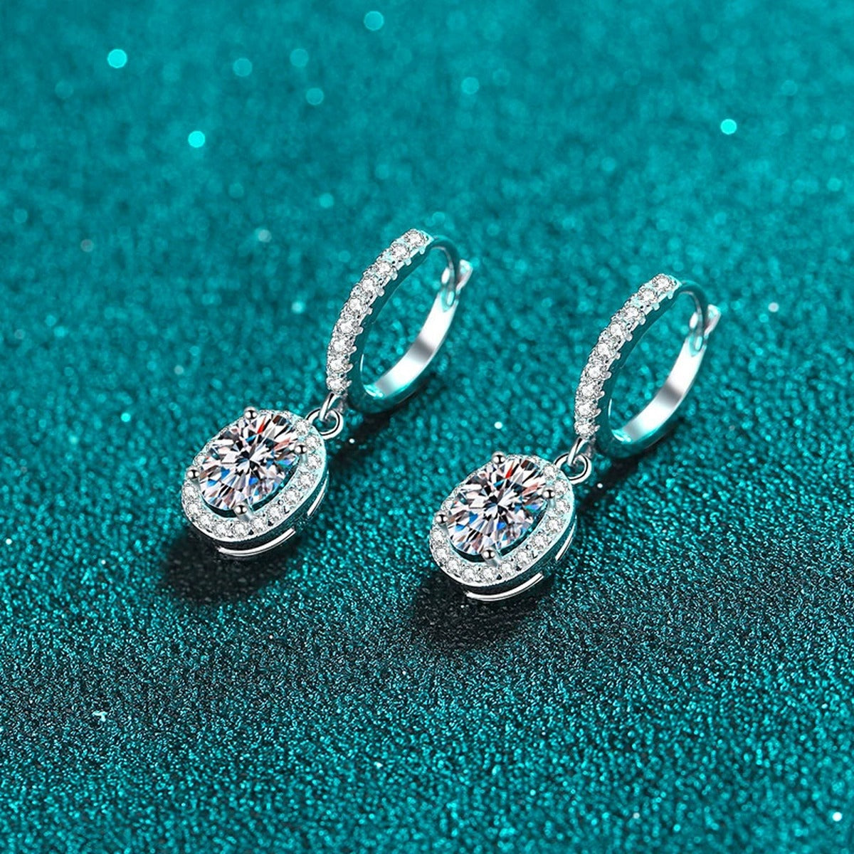 Oval Moissanite Hoop Dangle Earrings with CZ in Rhodium-Plated S925 sterling silver product scene view showing angled setting detail, moissanite setting, and hoop dangle earrings design