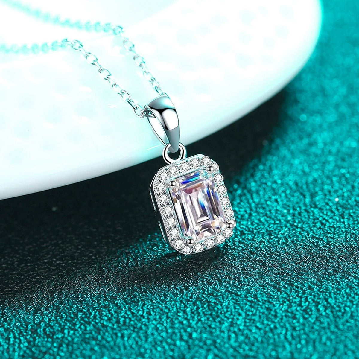Emerald and Radiant Cut Moissanite Pendant Necklace with CZ in Rhodium-Plated S925 sterling silver blue display scene showing chain and stone layout