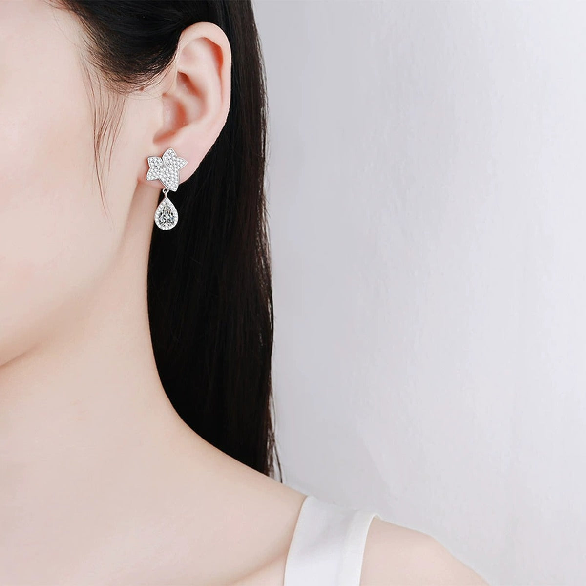 Star and Pear Moissanite Stud Dangle Earrings with CZ in Rhodium-Plated S925 sterling silver worn on ear by model showing scale, placement, and stud dangle earrings styling