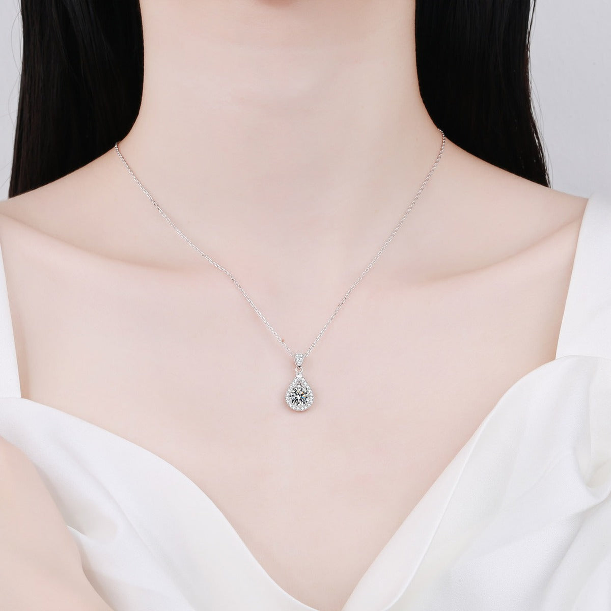 Teardrop Halo Round Moissanite Necklace with CZ in Rhodium-Plated S925 sterling silver neckline model view showing pendant scale and adjustable chain