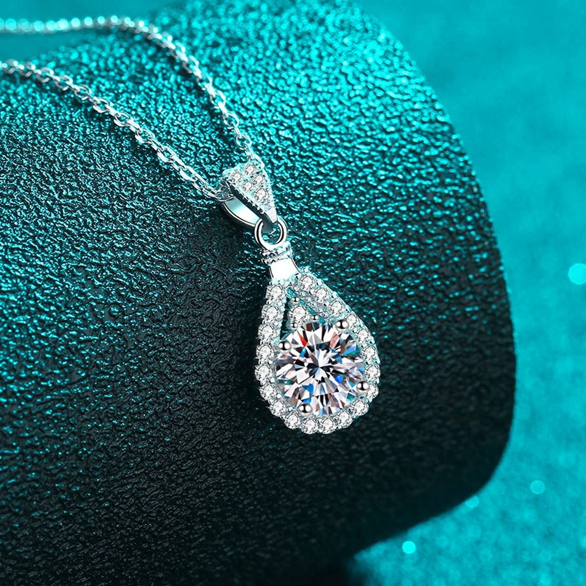 Teardrop Halo Round Moissanite Necklace with CZ in Rhodium-Plated S925 sterling silver blue display scene showing chain and stone layout