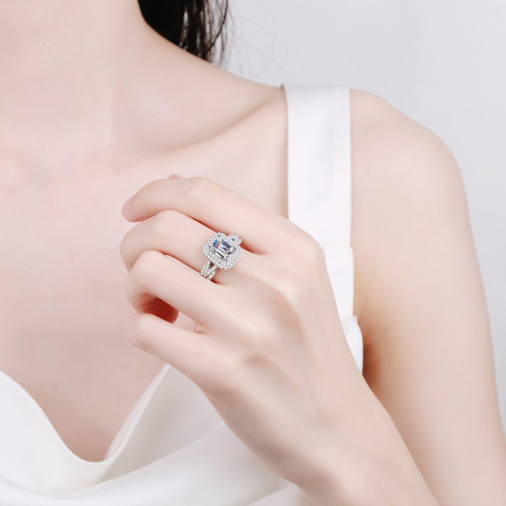 Emerald and Radiant Cut Moissanite Engagement Ring with CZ worn on hand to show ring scale, center stone size, and rhodium-plated finish