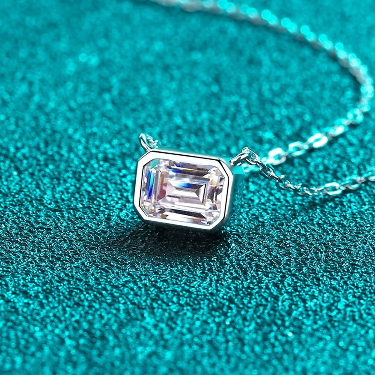 Emerald Cut Solitaire Moissanite Necklace in Rhodium-Plated S925 sterling silver close-up product scene showing pendant setting