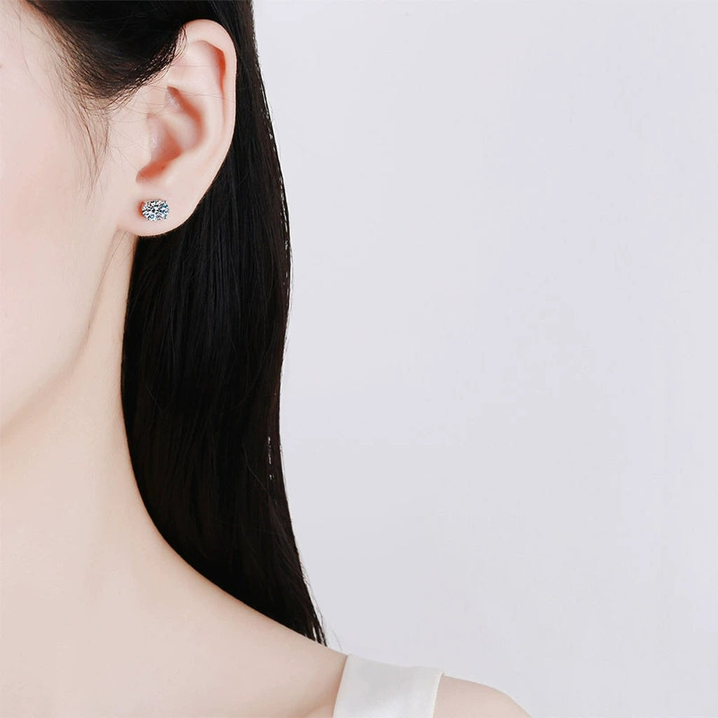 Oval Moissanite Stud Earrings in Rhodium-Plated S925 sterling silver worn on ear by model showing scale, placement, and stud earrings styling