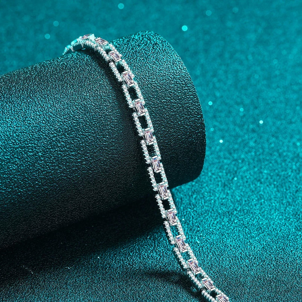 Emerald and Round Moissanite Tennis Bracelet in Rhodium-Plated S925 sterling silver angled product display showing bracelet silhouette