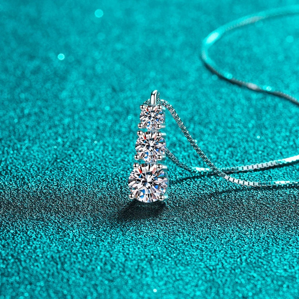 Graduated Moissanite Pendant Necklace in Rhodium-Plated S925 sterling silver blue display scene showing chain and stone layout