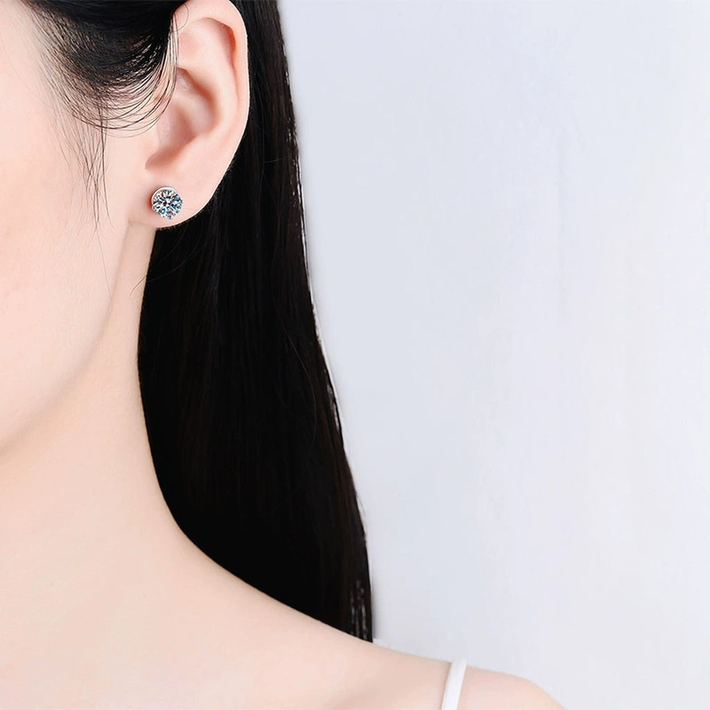 Round Moissanite Screw Back Stud Earrings in Rhodium-Plated S925 sterling silver worn on ear by model showing scale, placement, and stud earrings styling