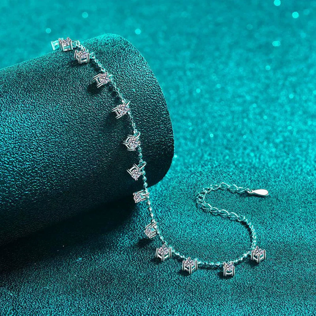 Moissanite Charm Station Bracelet in Rhodium-Plated S925 sterling silver angled product display showing bracelet silhouette