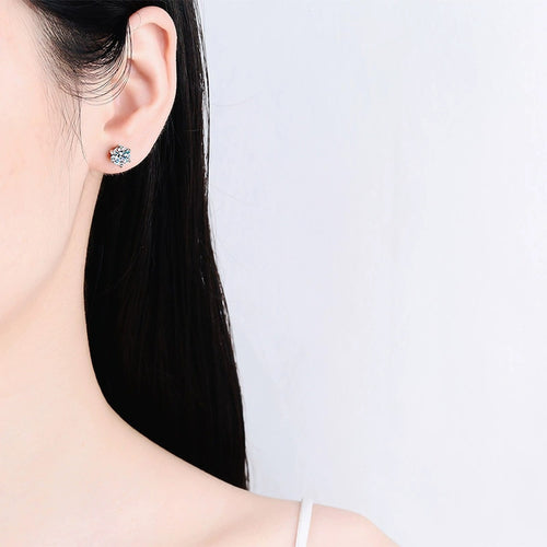 Classic Round Moissanite Stud Earrings in Rhodium-Plated S925 sterling silver worn on ear by model showing scale, placement, and stud earrings styling