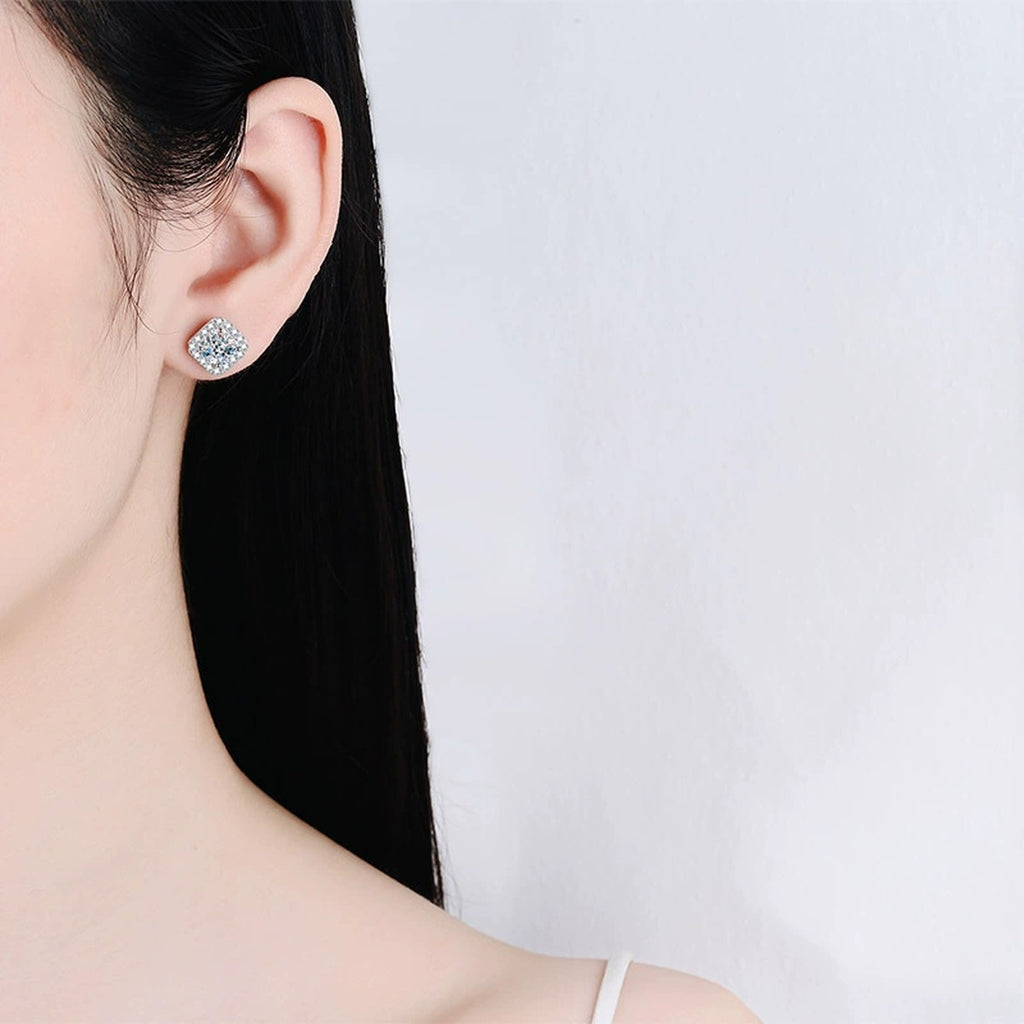 Princess Cut Halo Moissanite Stud Earrings with CZ in Rhodium-Plated S925 sterling silver worn on ear by model showing scale, placement, and stud earrings styling