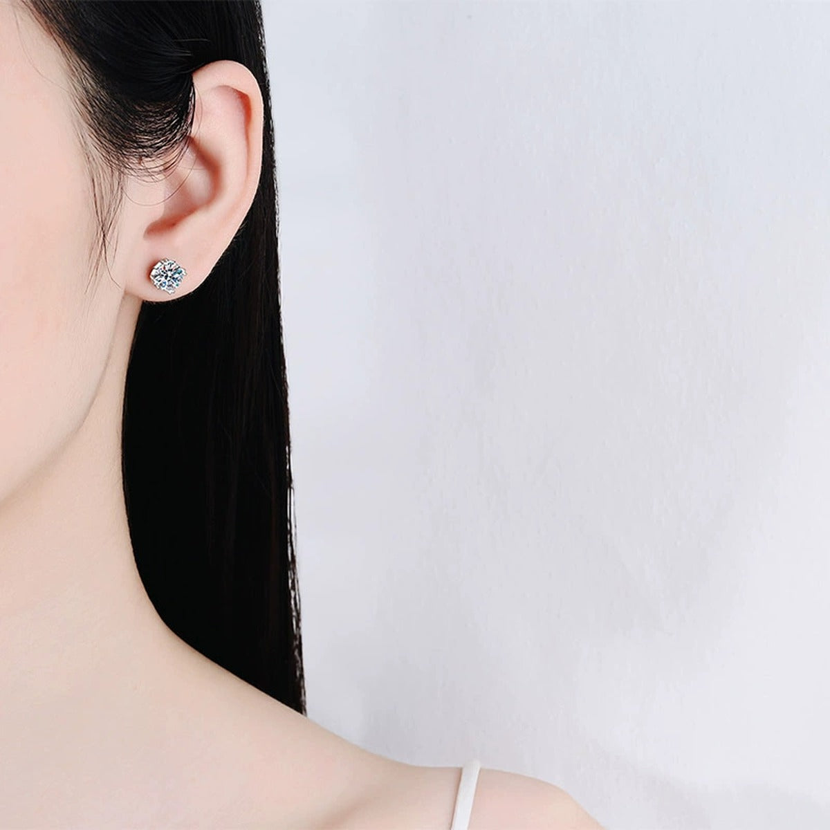 Round Moissanite Screw Back Stud Earrings in Rhodium-Plated S925 sterling silver worn on ear by model showing scale, placement, and stud earrings styling