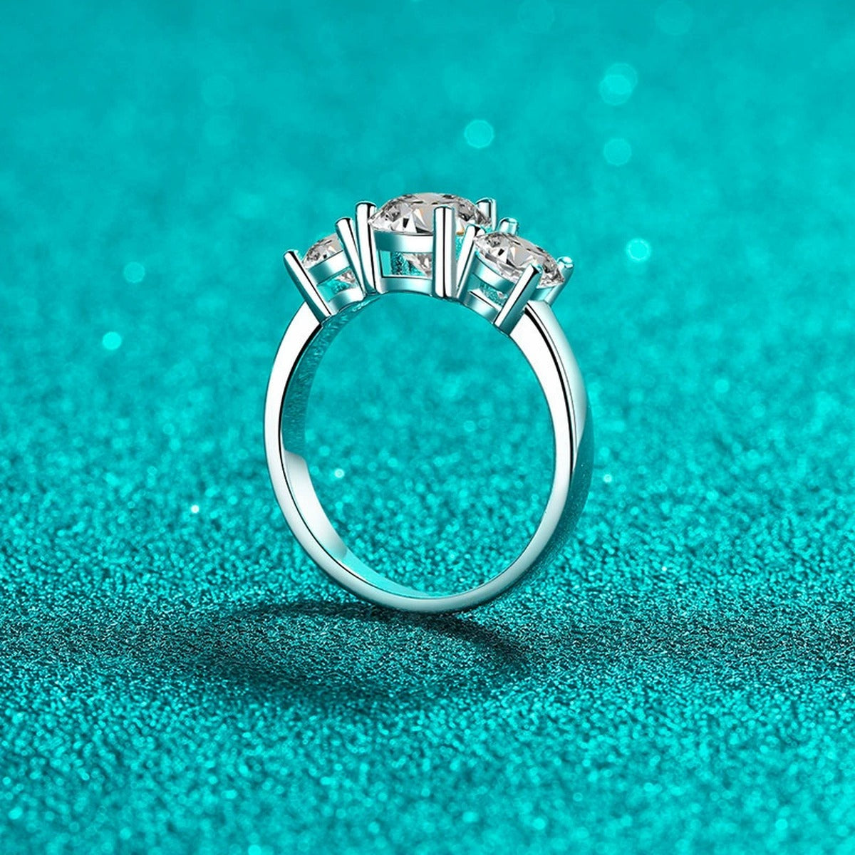 Three Stone Round Moissanite Ring product view showing moissanite setting and rhodium finish