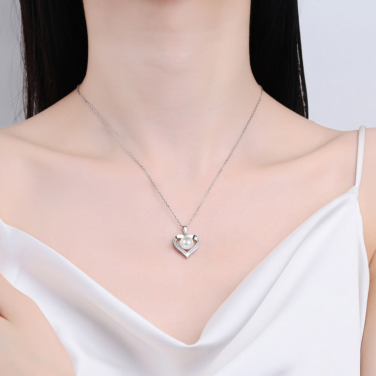 Heart Moissanite Pearl Pendant Necklace in Rhodium-Plated S925 sterling silver neckline model view showing pendant scale and adjustable chain
