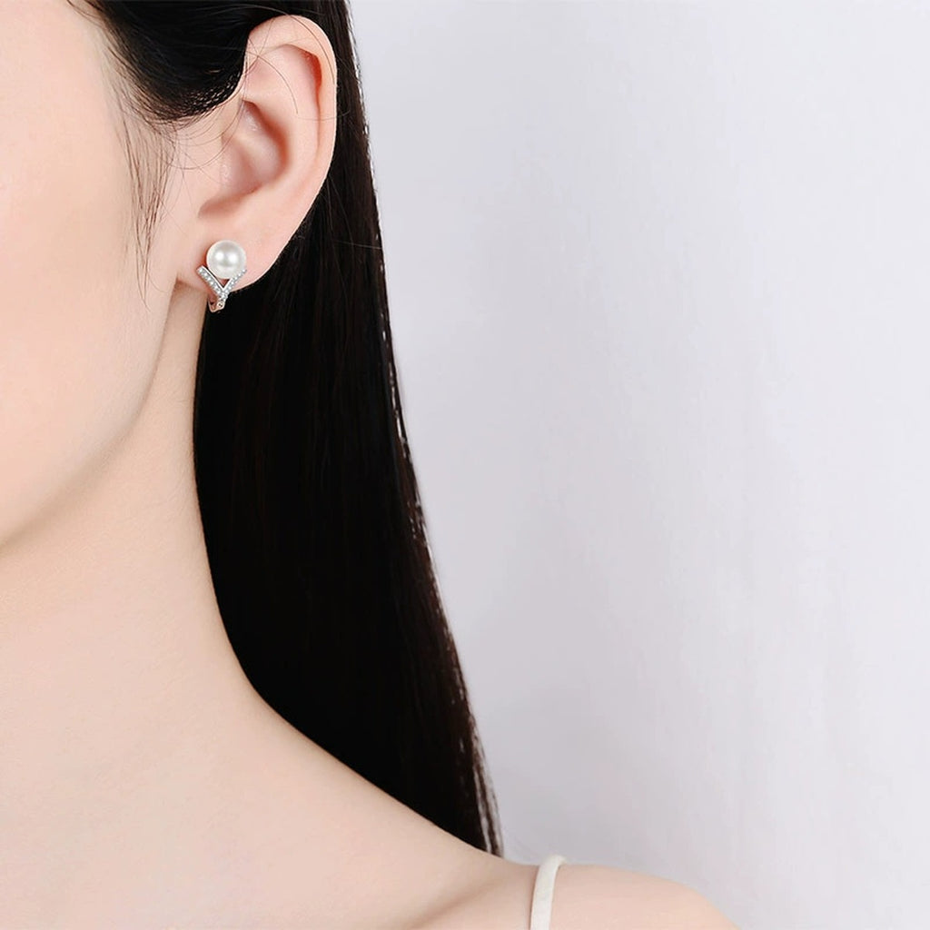 Pearl and Moissanite Huggie Hoop Earrings in Rhodium-Plated S925 sterling silver worn on ear by model showing scale, placement, and huggie hoop earrings styling
