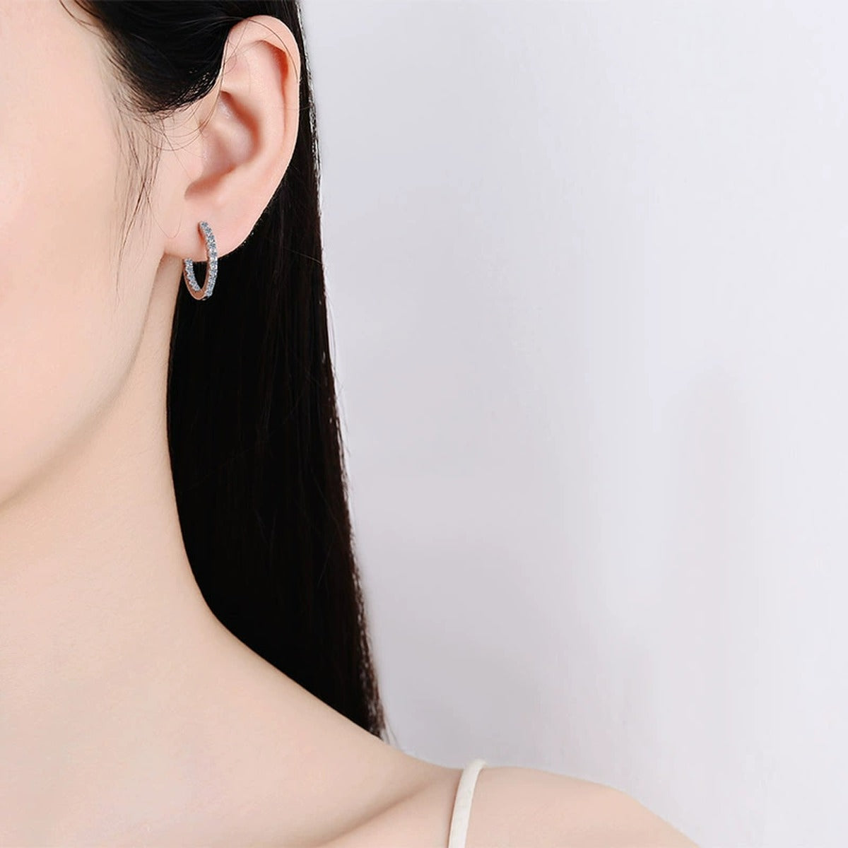 Pave Moissanite Hoop Earrings in Rhodium-Plated S925 sterling silver worn on ear by model showing scale, placement, and hoop earrings styling